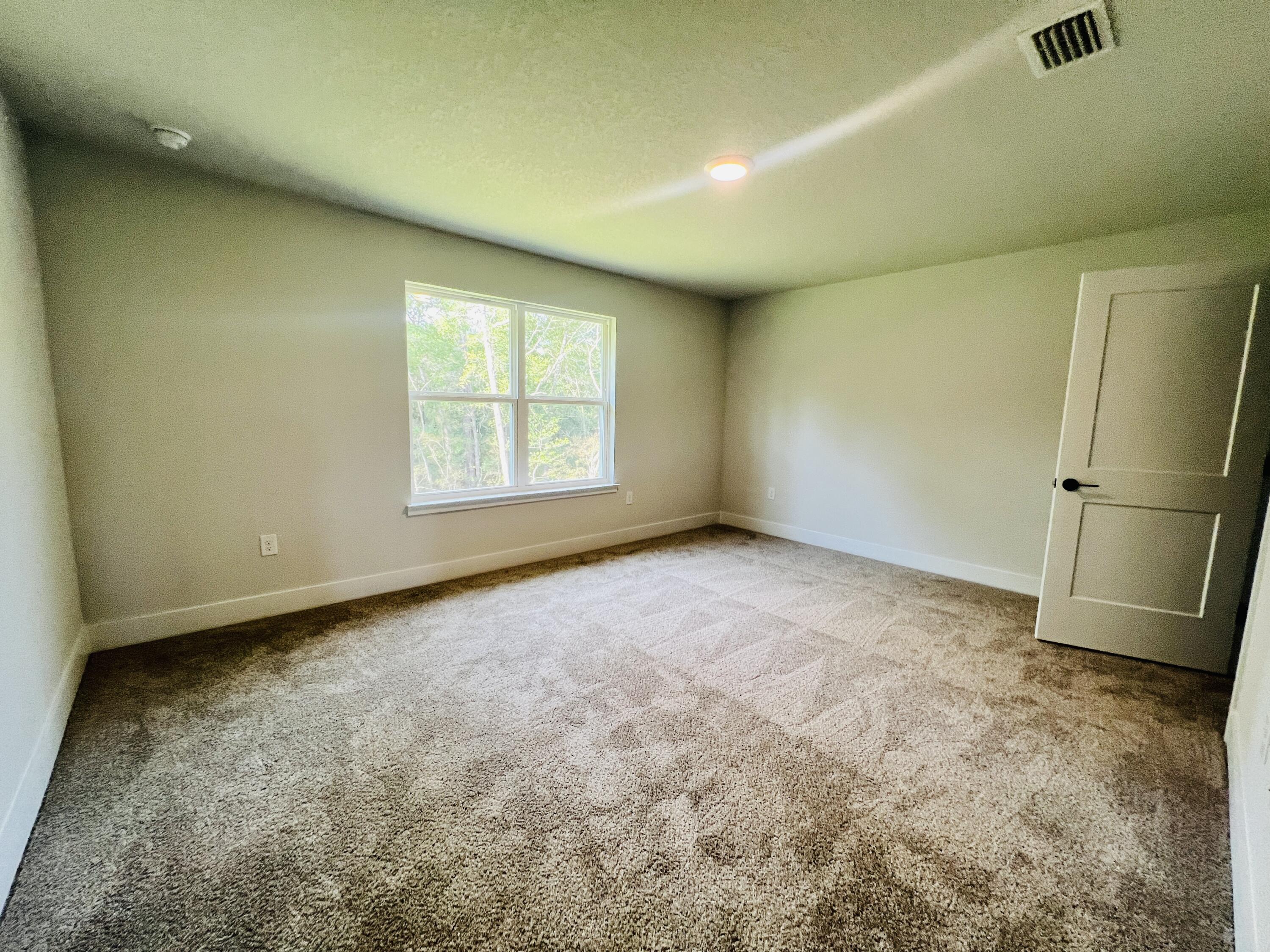 5303 Hidden Pines Circle Milton, FL 32583 - Photo 18 of 22 an empty room with a window