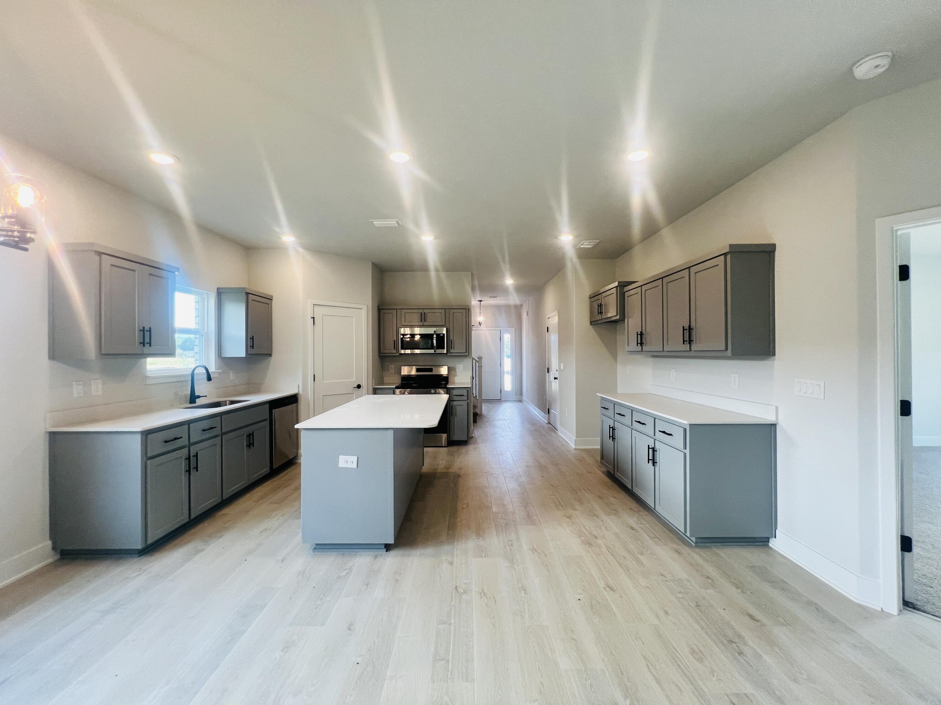 5303 Hidden Pines Circle Milton, FL 32583 - Photo 8 of 22 a large kitchen with stainless steel appliances microwave and stove