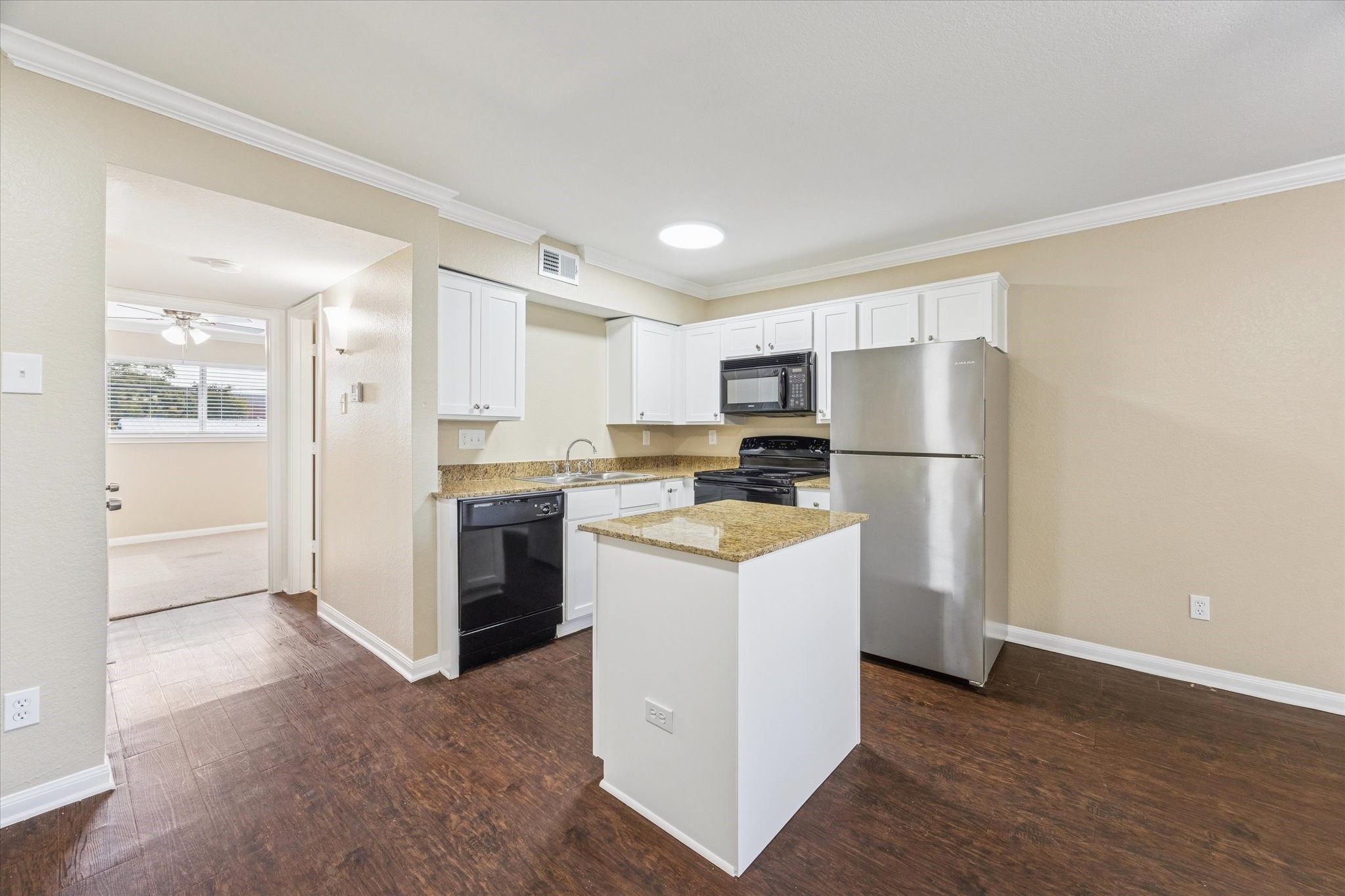300 Pecore Street, Unit 19 Houston, TX 77009 - Photo 5 of 10 a kitchen with a refrigerator a stove top oven and white cabinets