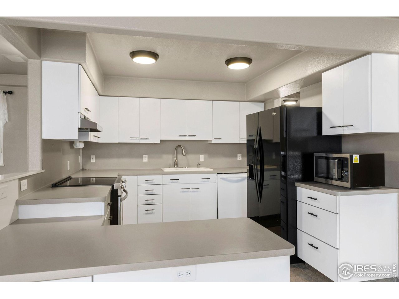 7770 Red Mountain Road Livermore, CO 80536 - Photo 11 of 36 a kitchen with a sink a stove a refrigerator and cabinets