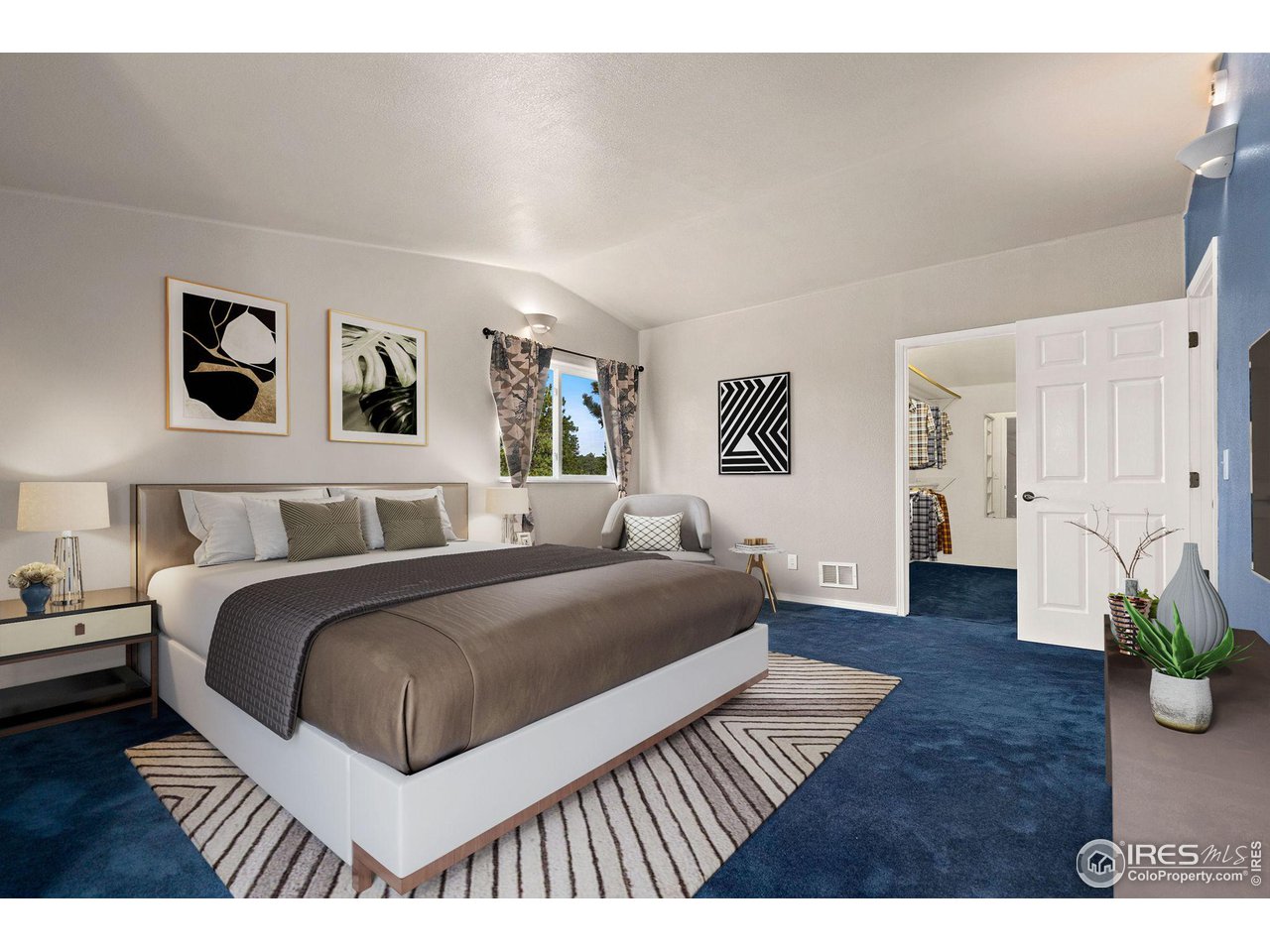 7770 Red Mountain Road Livermore, CO 80536 - Photo 13 of 36 a bedroom with a large bed and paintings on the wall