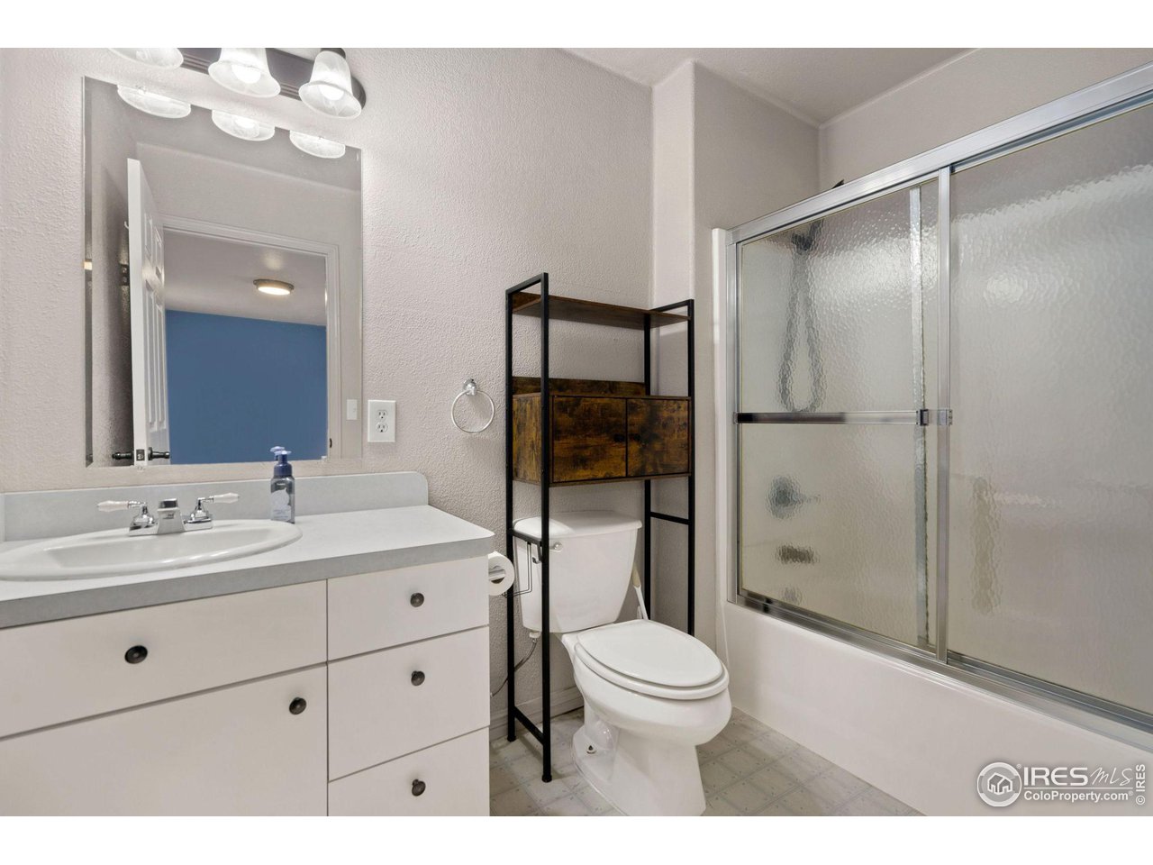 7770 Red Mountain Road Livermore, CO 80536 - Photo 20 of 36 a bathroom with a toilet a sink and glass door