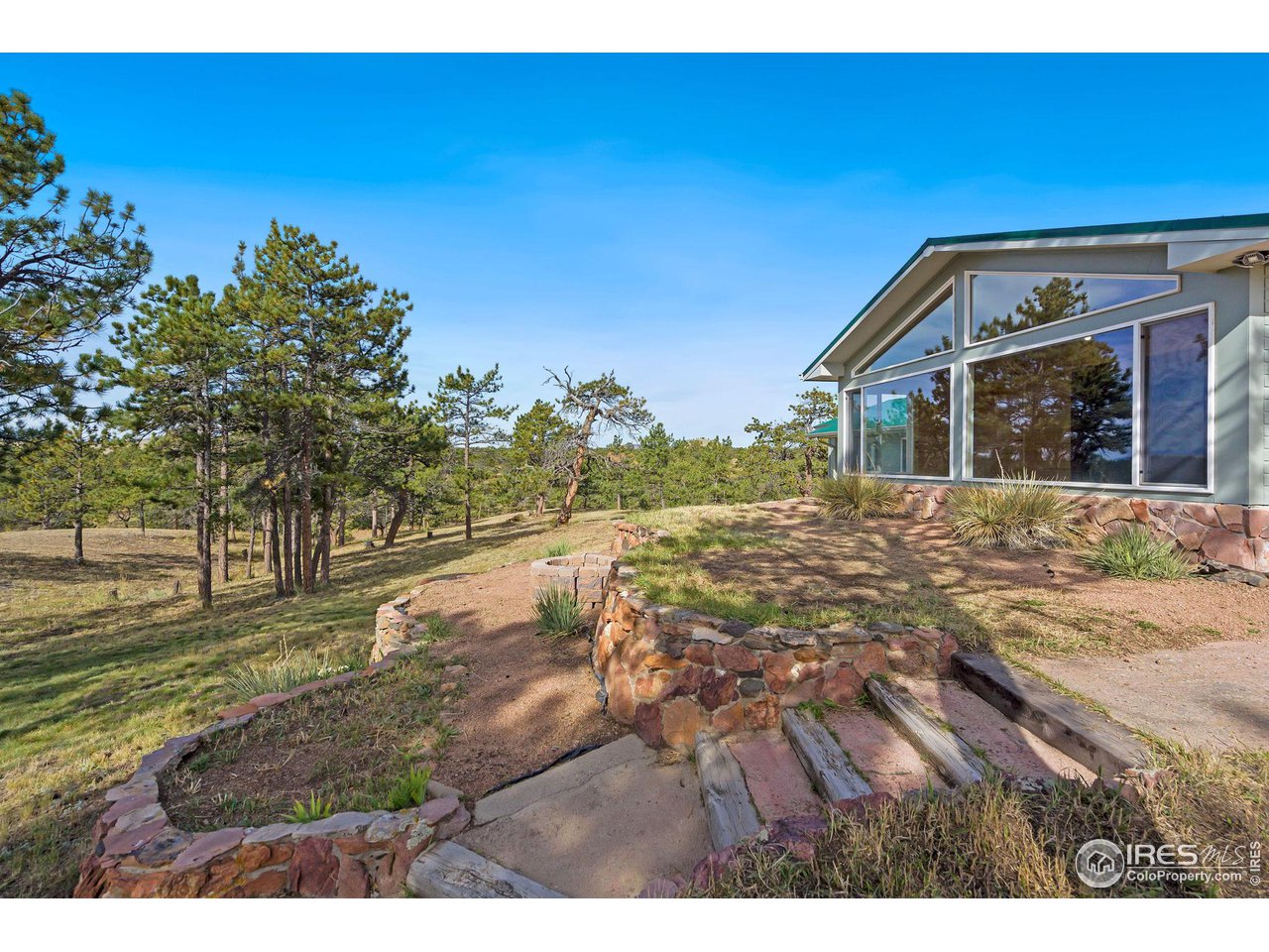 7770 Red Mountain Road Livermore, CO 80536 - Photo 4 of 36 a view of a house with a yard