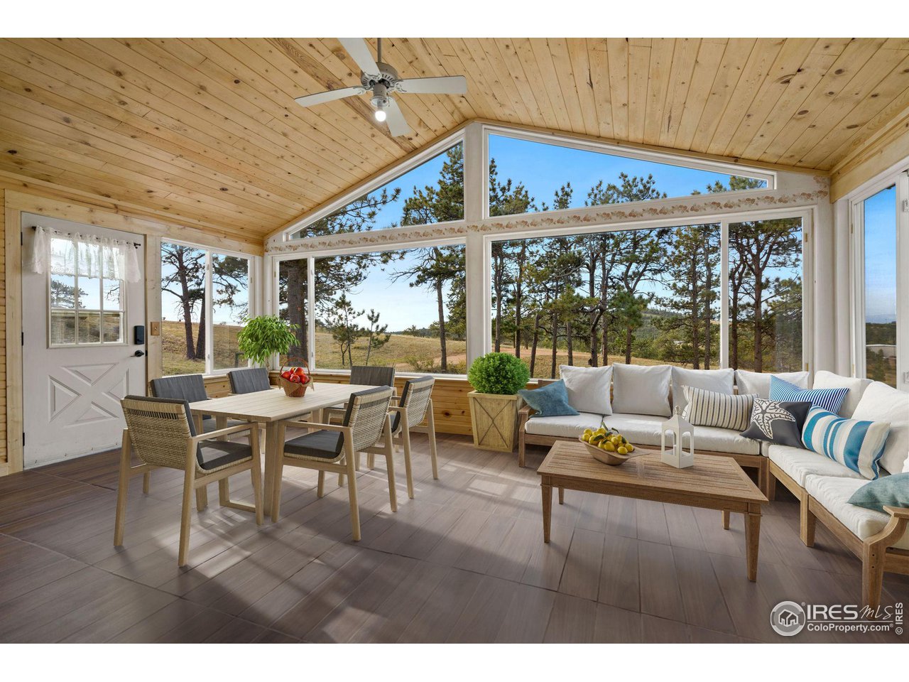 7770 Red Mountain Road Livermore, CO 80536 - Photo 6 of 36 a living room with furniture a rug and a large window