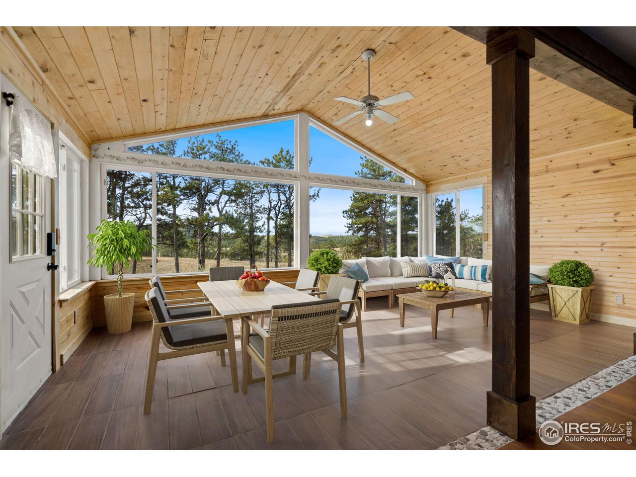 7770 Red Mountain Road Livermore, CO 80536 - Photo 8 of 36 a view of a dining room with furniture wooden floor and chandelier