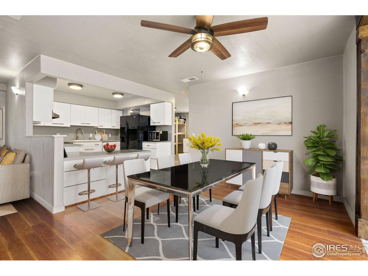 7770 Red Mountain Road Livermore, CO 80536 - Photo 9 of 36 a kitchen with stainless steel appliances kitchen island granite countertop a dining table chairs and white cabinets