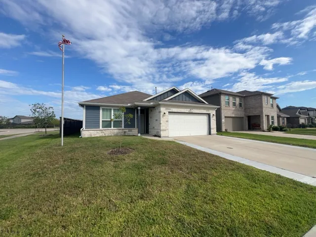 a view of a house next to a yard with big trees