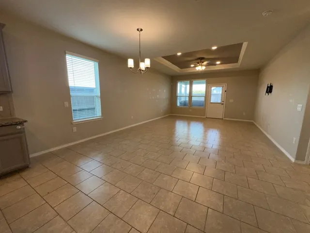 an empty room with projector and windows