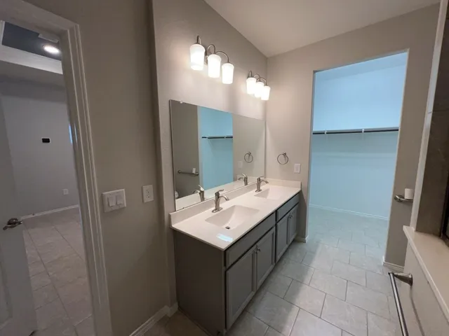 a bathroom with a sink double vanity and a mirror