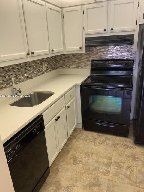 632 Northwest 13th Street, Unit 230 Boca Raton, FL 33486 - Photo 2 of 12 a kitchen with granite countertop white cabinets and stainless steel appliances