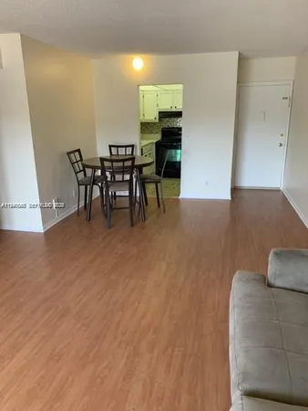 a view of a livingroom with furniture and workspace
