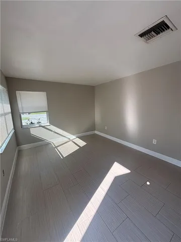 a view of an empty room and a window