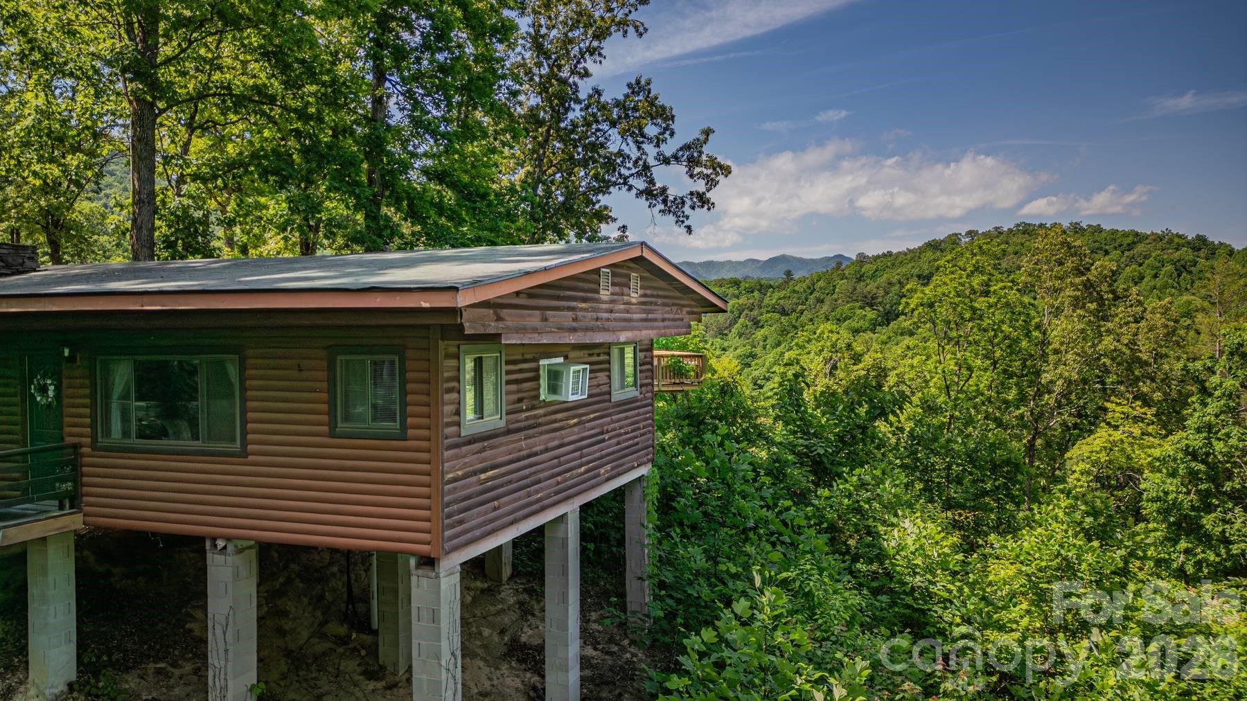 319 Blue Ridge Parkway, Unit 53 Bryson City, NC 28713 - Photo 17 of 22 a small house with a wooden fence