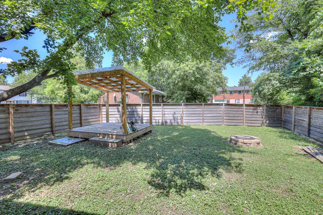 a view of a backyard with wooden fence