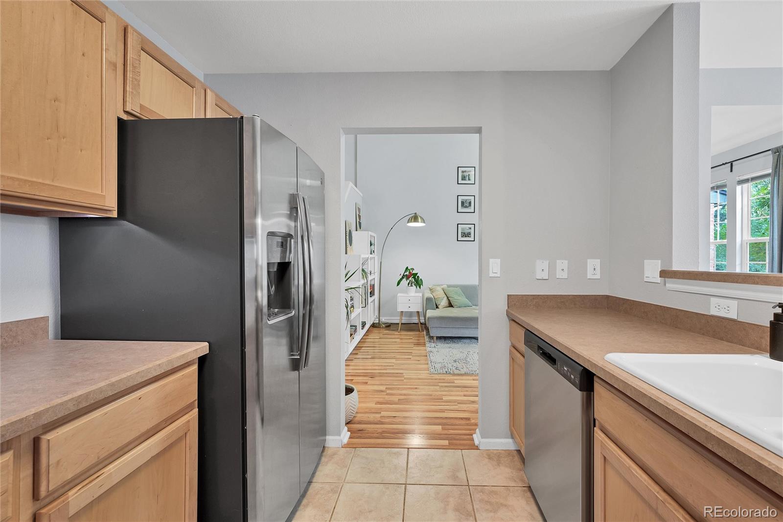 893 South Evanston Circle Aurora, CO 80012 - Photo 11 of 28 a kitchen with a refrigerator and a sink