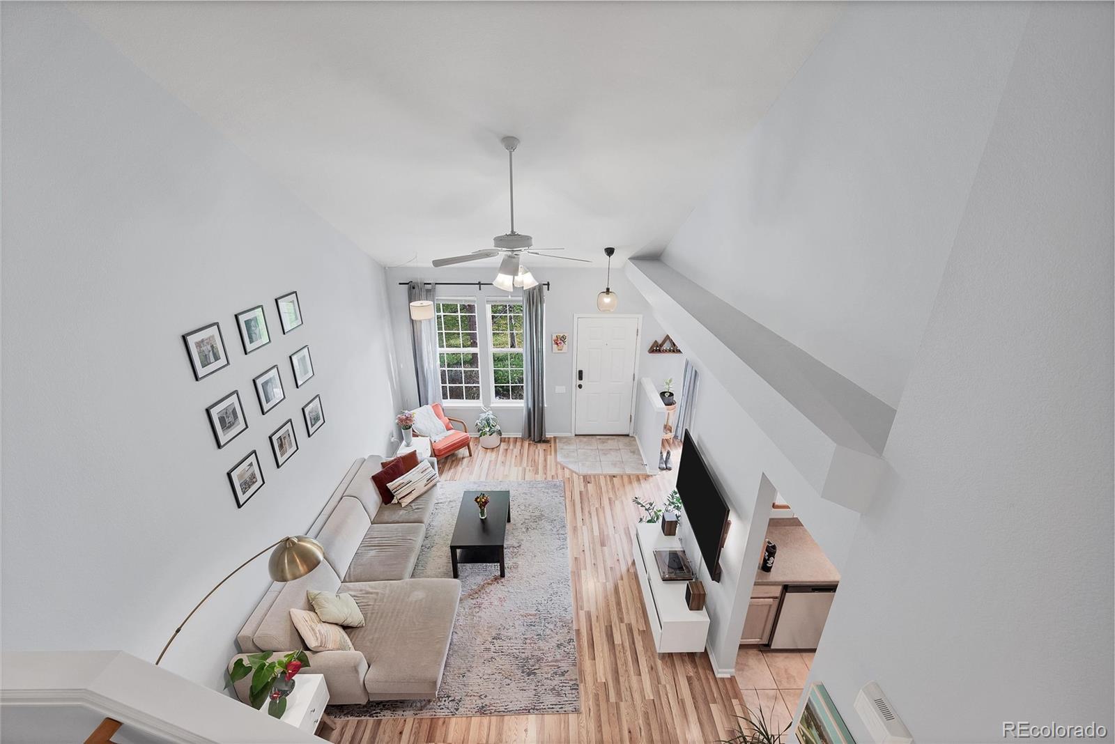 893 South Evanston Circle Aurora, CO 80012 - Photo 14 of 28 a view of a livingroom with furniture staircase and kitchen view