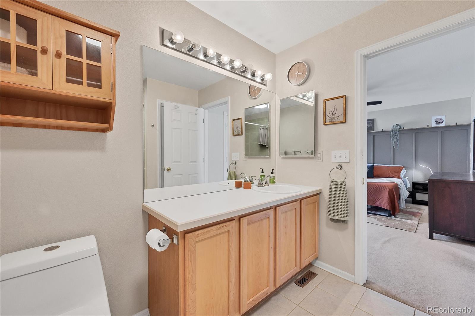 893 South Evanston Circle Aurora, CO 80012 - Photo 20 of 28 a bathroom with a sink a vanity and a mirror