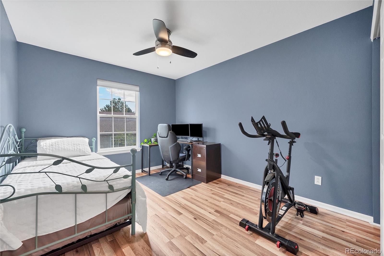 893 South Evanston Circle Aurora, CO 80012 - Photo 23 of 28 a bedroom with bed and a chandelier