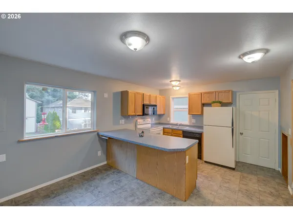 a kitchen with sink and refrigerator
