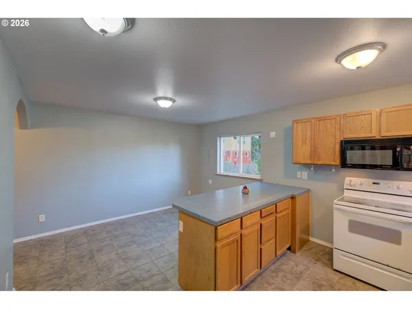 a kitchen that has a sink and a stove in it