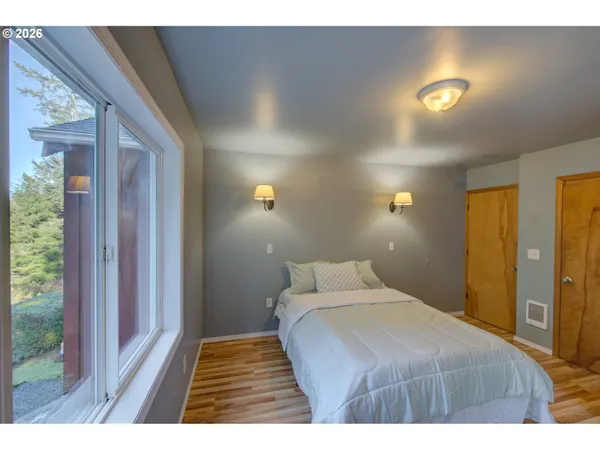 a bedroom with a bed and a night stand