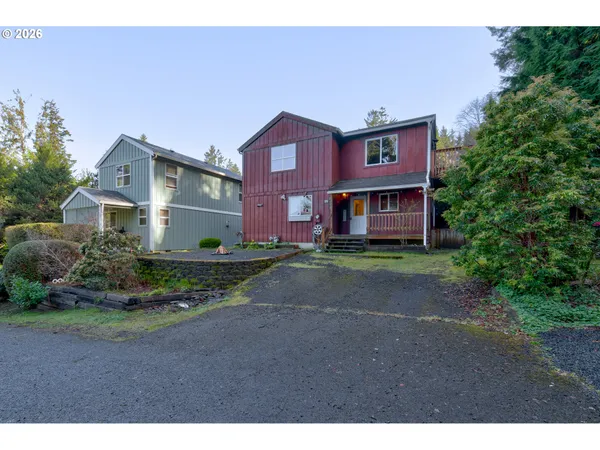 a front view of a house with a yard and a garage