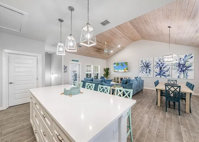 a large kitchen with a table and chairs