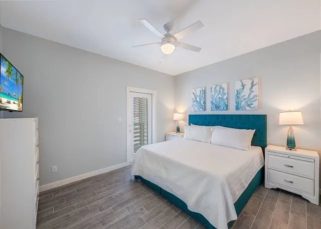 a bedroom with a large bed and a chandelier