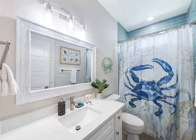 a bathroom with a sink vanity mirror and toilet