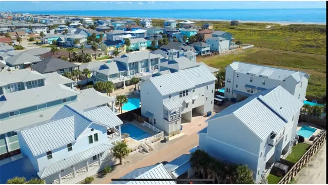 an aerial view of a house with a ocean view