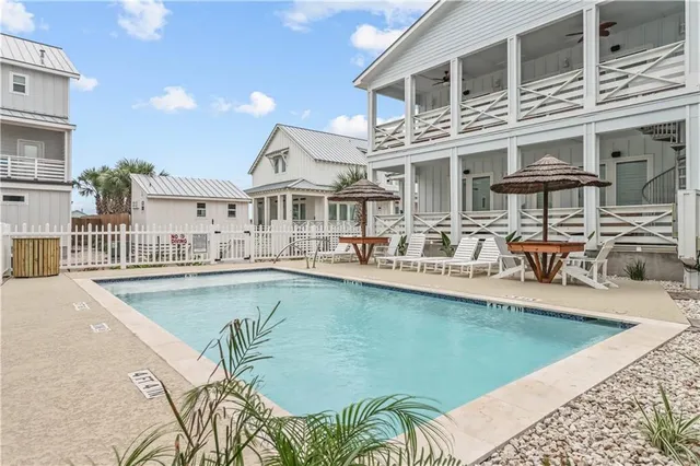 a view of a patio with swimming pool table and chairs