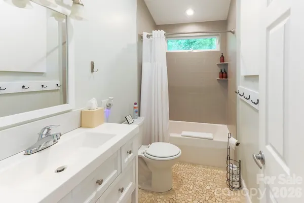 a bathroom with a sink toilet and shower