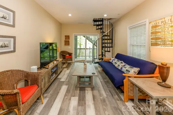 a living room with furniture fireplace and wooden floor