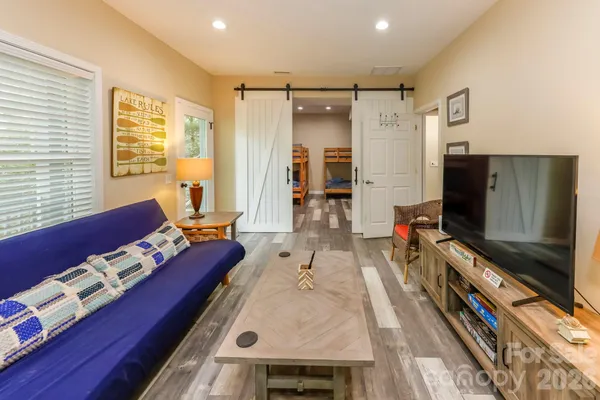 a living room with furniture and a flat screen tv