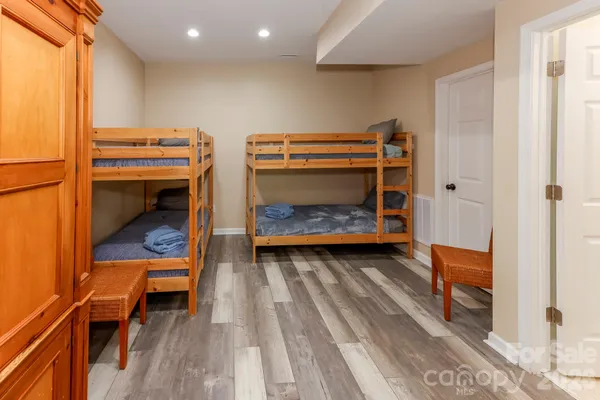 a bedroom with two bunk beds and a couch
