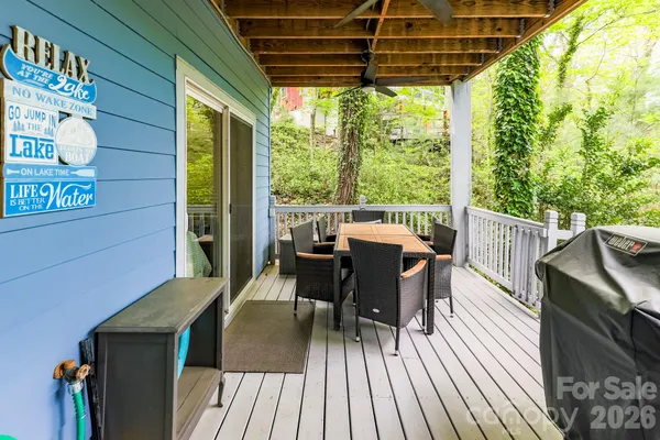 a view of a roof deck with table and chairs and wooden floor