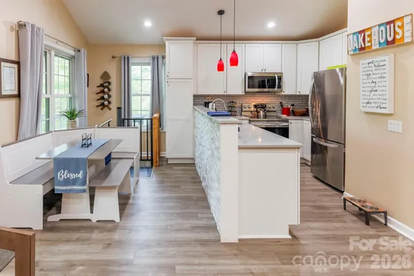 a kitchen with stainless steel appliances kitchen island granite countertop a refrigerator and a stove top oven