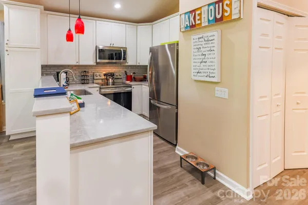 a kitchen with stainless steel appliances a refrigerator and a stove
