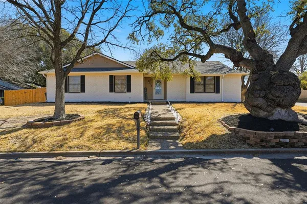 a front view of a house with yard yard and garage