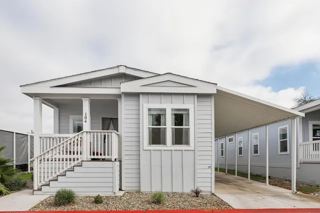a front view of a house with wooden fence