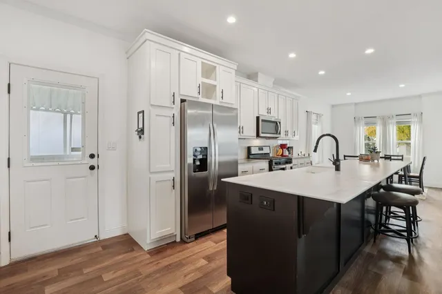 a kitchen with stainless steel appliances a refrigerator sink and cabinets