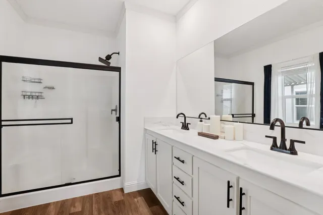 a bathroom with a double vanity sink and mirror