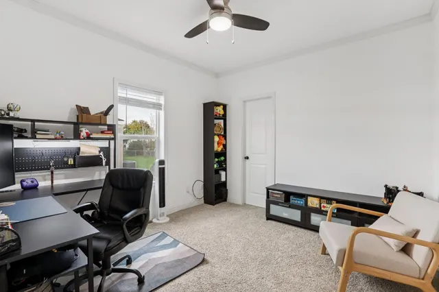 a livingroom with workspace and a couch