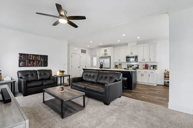 a living room with furniture kitchen and a kitchen view