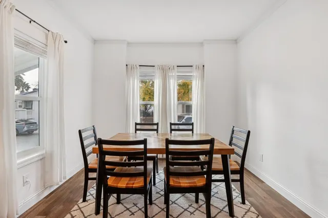 a view of a dining room with furniture and window