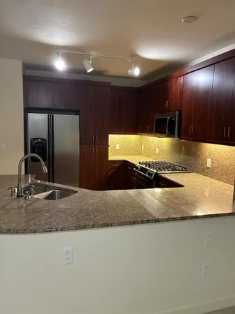 a kitchen with kitchen island sink and faucet