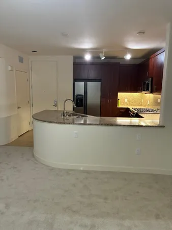 a view of a large kitchen with a sink and a large mirror