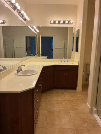 a bathroom with a sink vanity and mirror