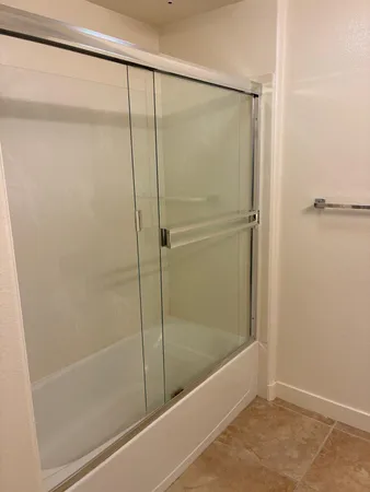 a bathroom with a glass shower door