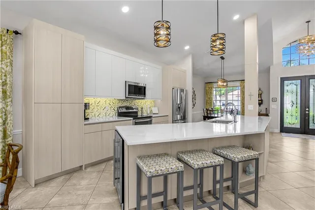 a kitchen with granite countertop cabinets and refrigerator